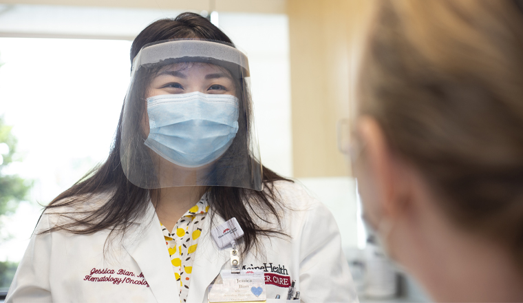 Jessica Bian, MD speaks with a patient