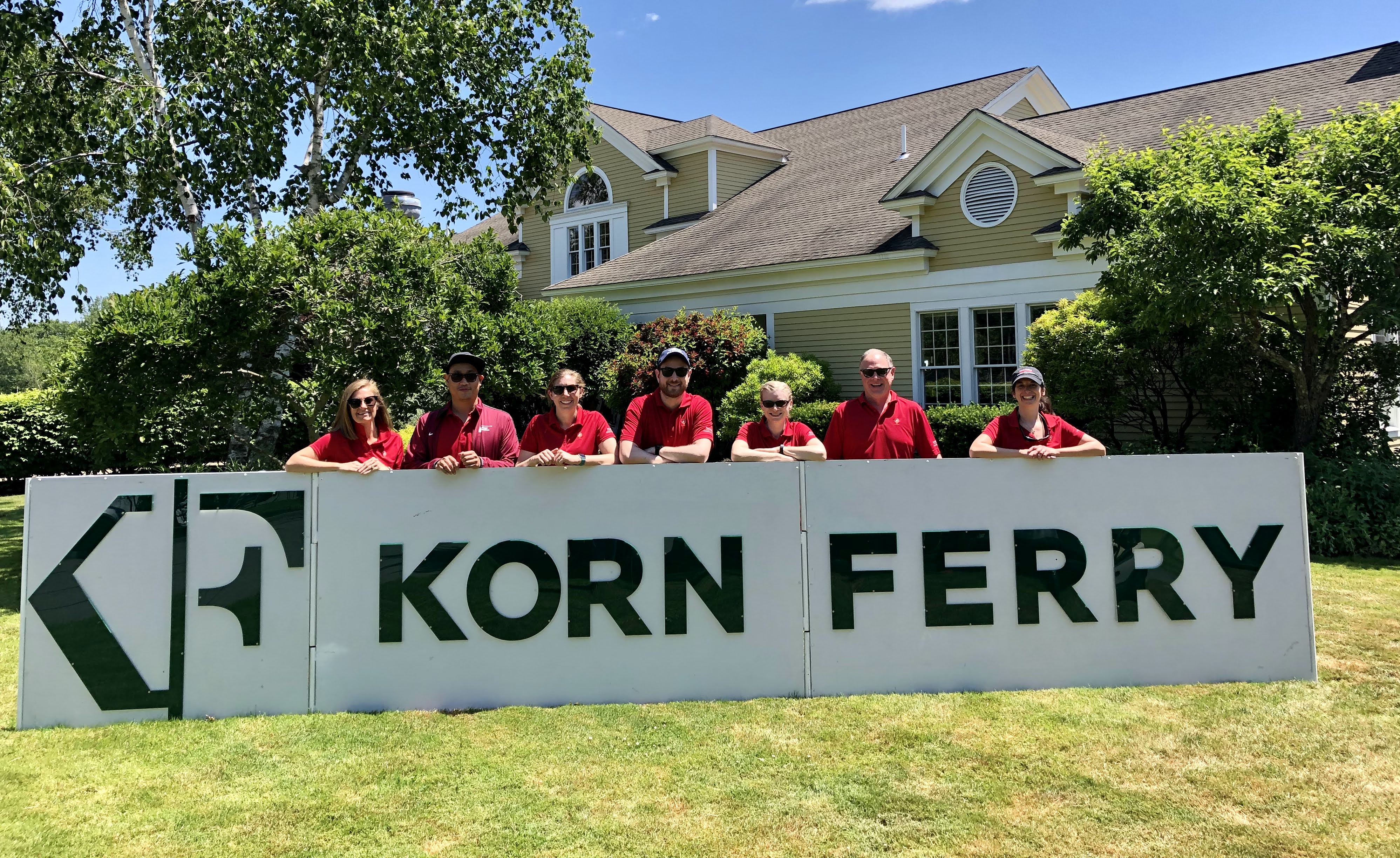 MMC Sports Medicine Fellows gathered around a sign that reads "Korn Ferry"
