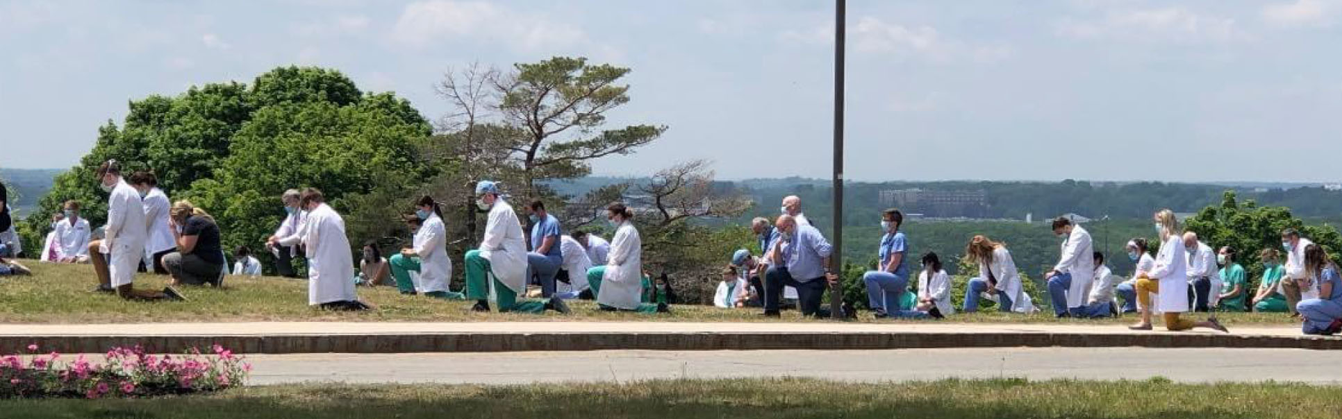 MaineHealth physicians and residents kneel in support of the Black Lives Matter movement at Maine Medical Center.