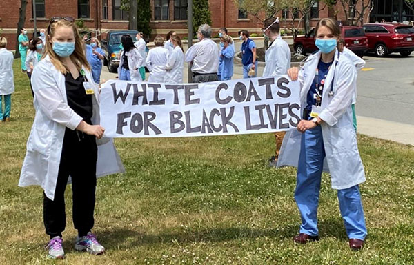 Two internal medicine-pediatrics residents join the Black Lives Matter demonstration at Maine Medical Center.