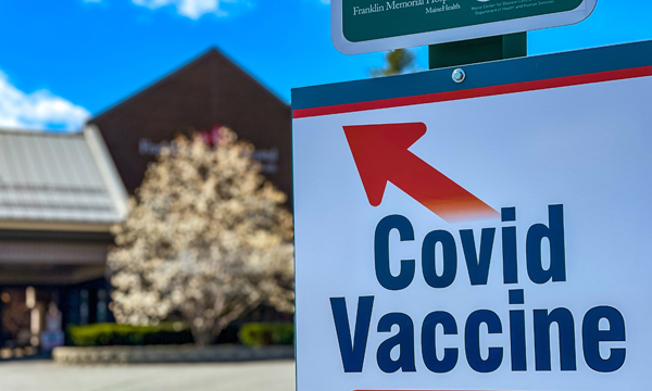 covid vaccine sign with arrow pointing to entrance