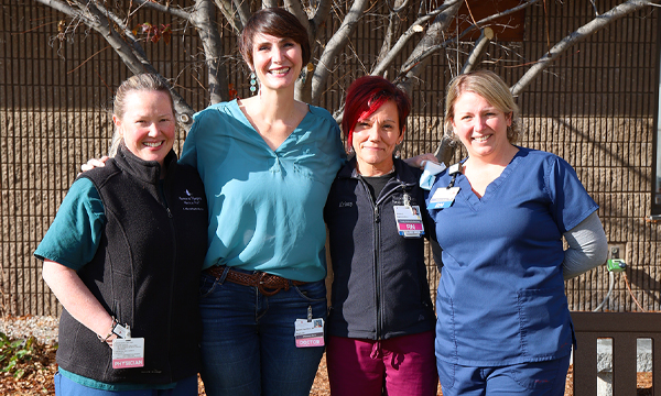 Dr. Lauren Frye, Dr. Rachel Hamilton, Krissy Collins, RN and Michelle Loeber, RN stand together outside under a tree.