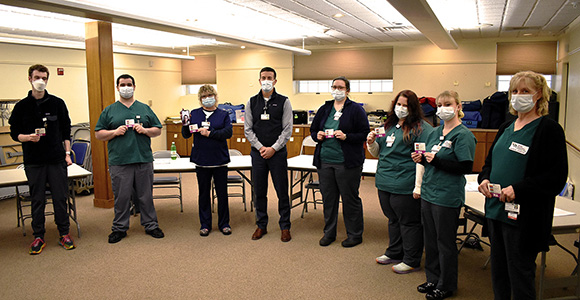 Group of socially-distanced medical assistant students wearing masks in a classroom setting