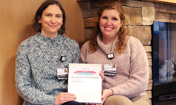 Doctors Charlotte Helvie and Kathryn Fekete hold a Memorial Hospital Excellence in Pediatric Care award plaque