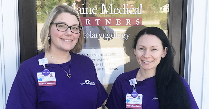 two care providers standing at the entrance of a Maine medical partners office